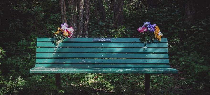 green bench with flowers