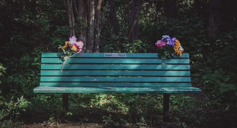 green bench with flowers