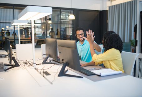 office-workers-doing-a-high-five-gesture-in-an-office
