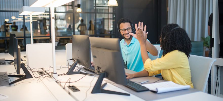office-workers-doing-a-high-five-gesture-in-an-office