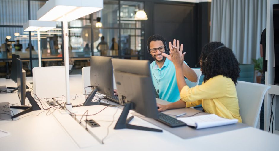 office-workers-doing-a-high-five-gesture-in-an-office