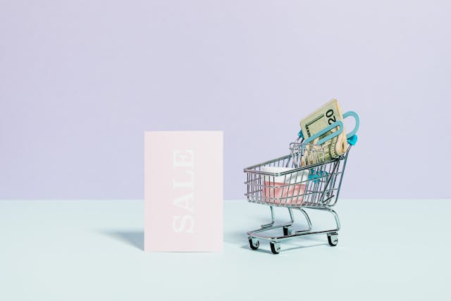 sale-sign-beside-a-miniature-shopping-cart